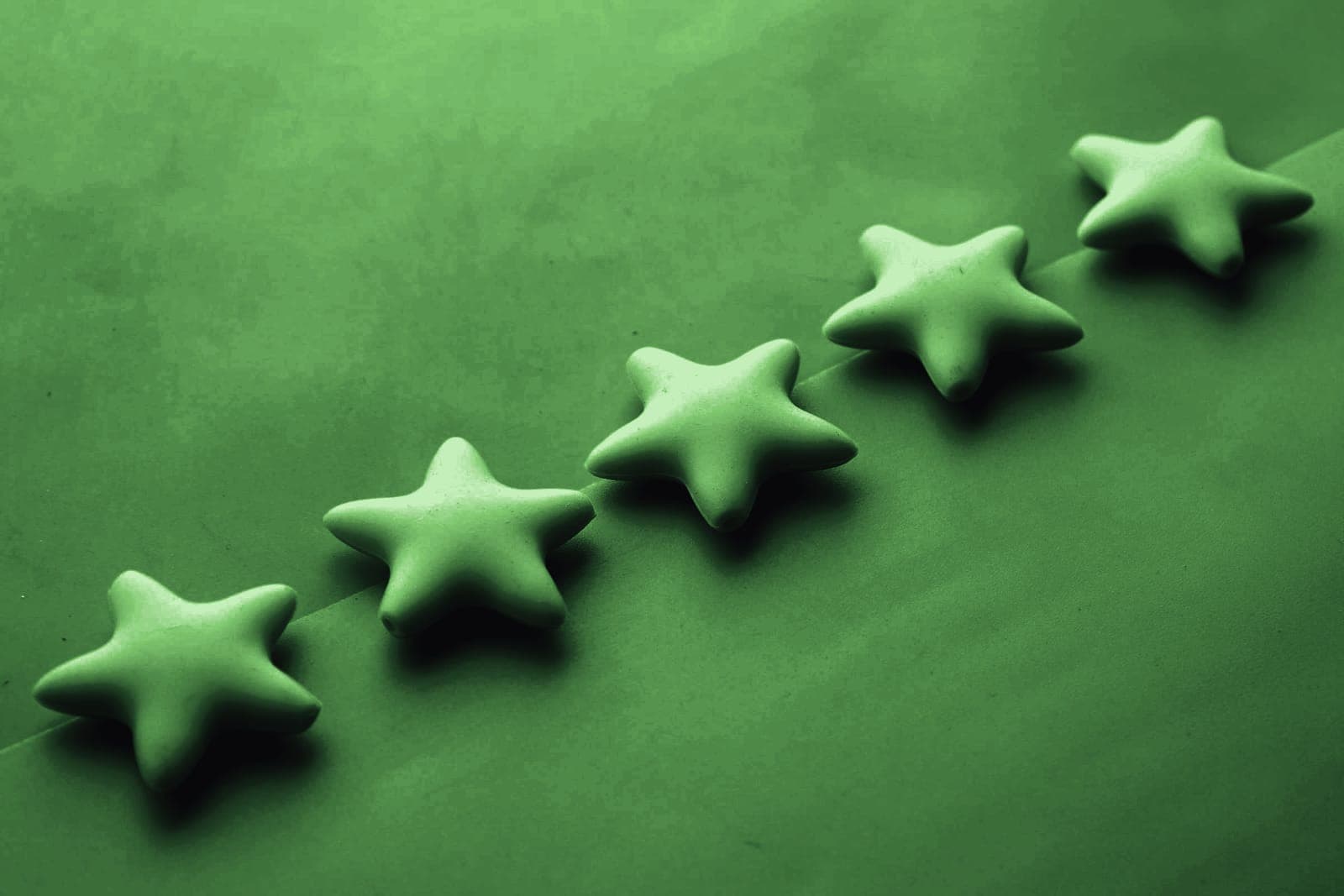 Five star shapes arranged in a rising line
